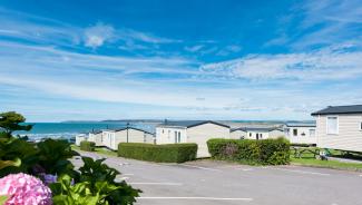 A view through a holiday park overlooking Westward Ho! beach