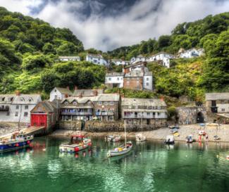 A harbour area at full tide with beautiful green coloured sea and forests surrounding the village houses