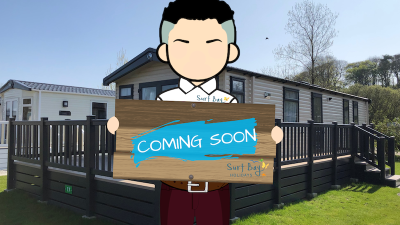 Picture of a Person Holding a 'Comming Soon' Board in front of a Holiday Home