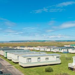 An image of holiday homes at Surf Bay Holiday park on a bright sunny day